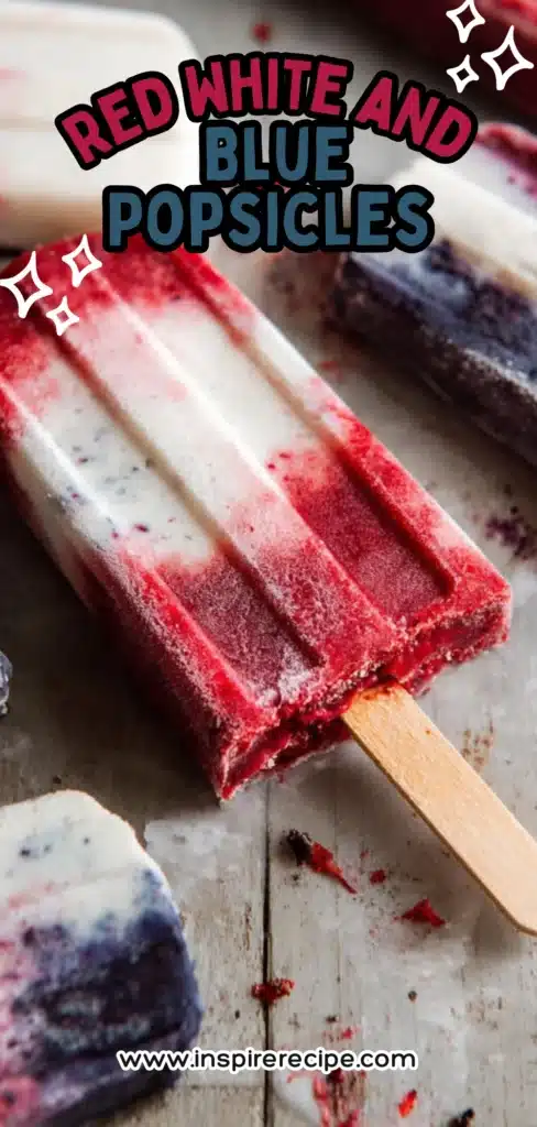 Red, white, and blue layered popsicles on wooden sticks, one with a bite taken.