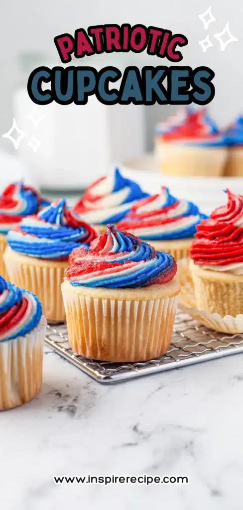Vanilla cupcake with red, white, and blue swirl frosting on a cooling rack.