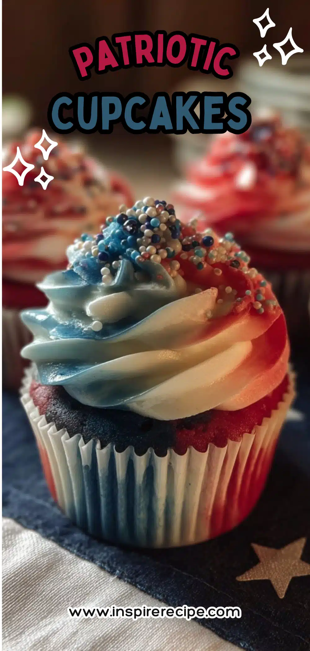 Cupcake with red, white, and blue striped buttercream frosting and sprinkles on a flag napkin.