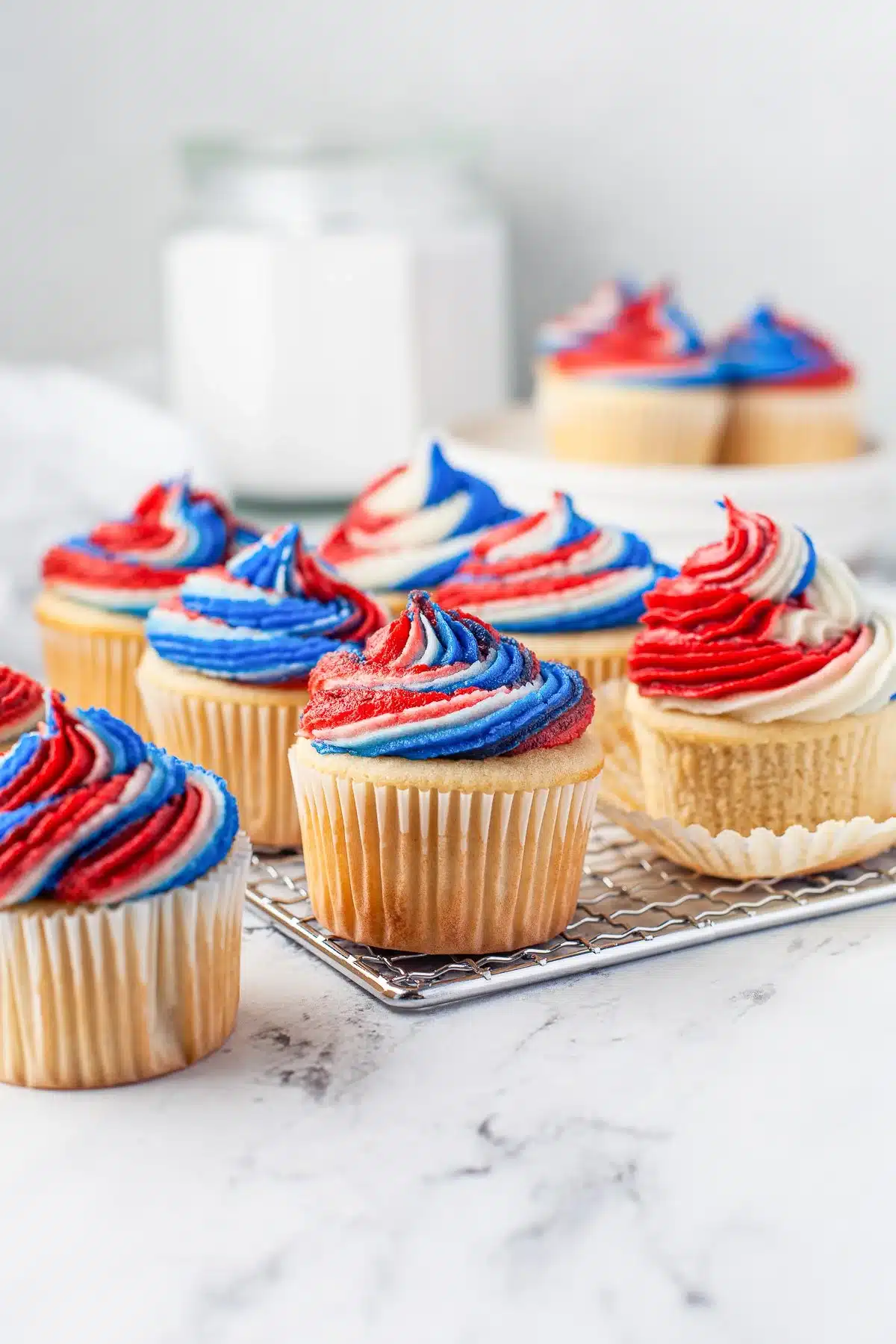 Patriotic cupcakes decorated with red, white, and blue frosting for festive celebrations