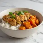 Healthy chicken and sweet potato rice bowl with vegetables