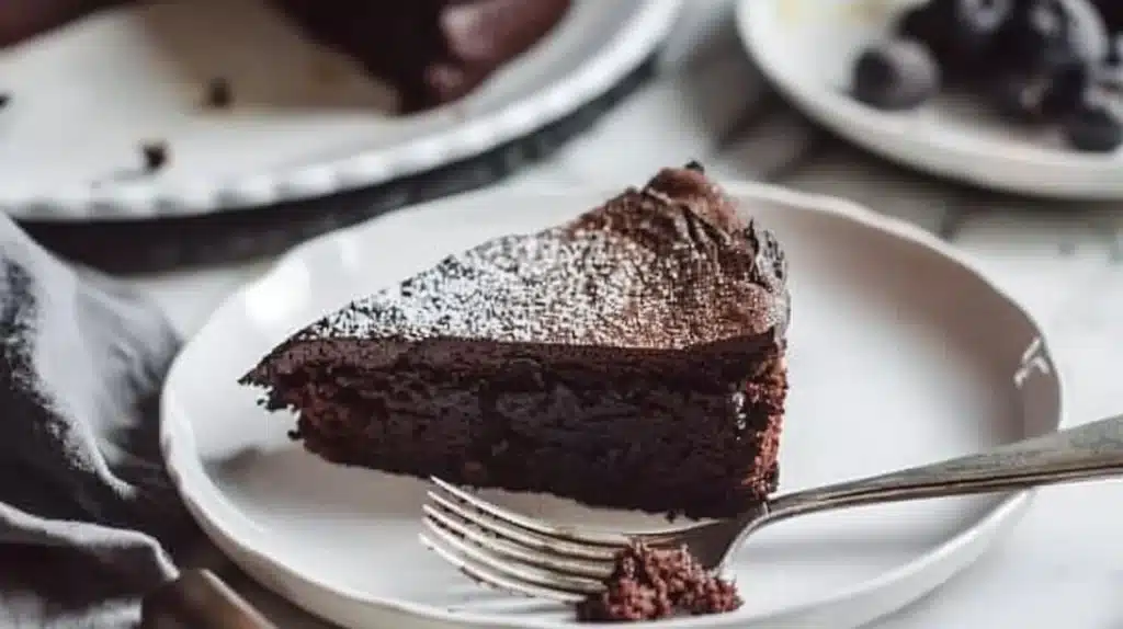Delicious 3-ingredient gluten free chocolate cake with rich chocolate frosting.