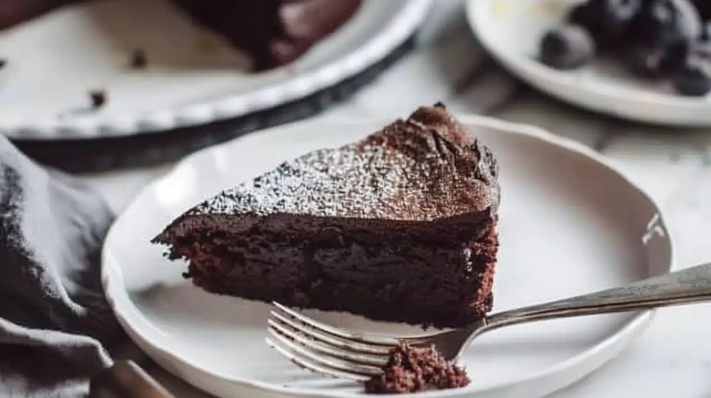 Delicious 3-ingredient gluten free chocolate cake with rich chocolate frosting.