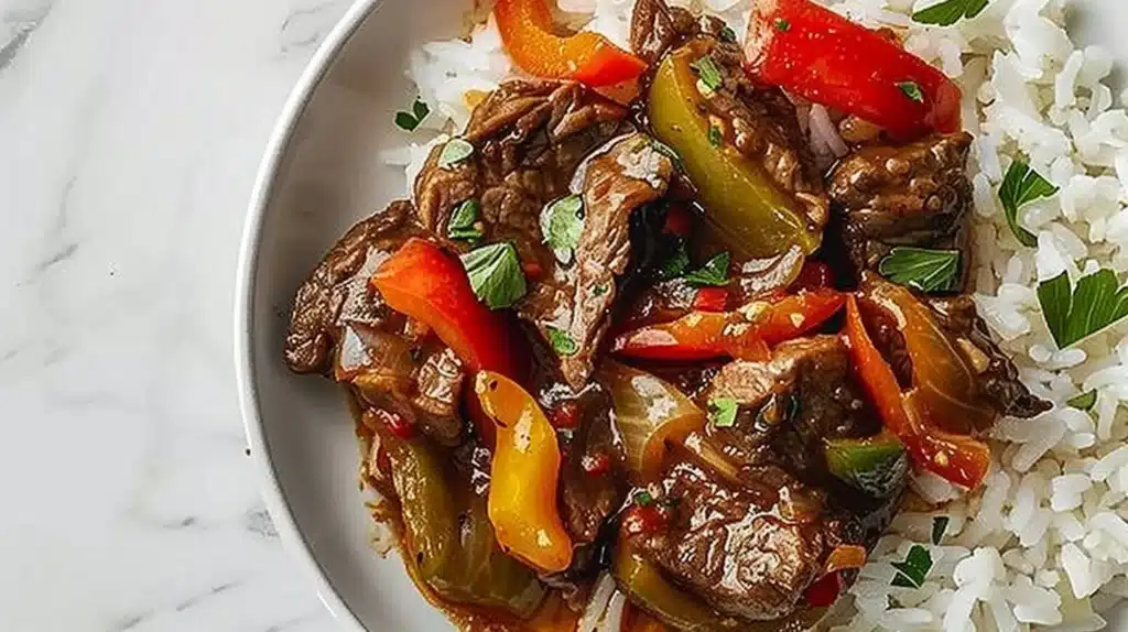 Delicious Crockpot Pepper Steak served with peppers and sauce in a bowl