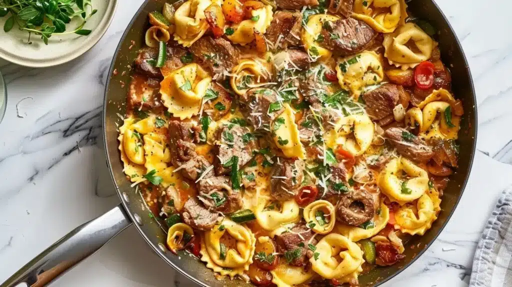 Delicious Garlic Steak Tortellini Skillet served in a pan with herbs