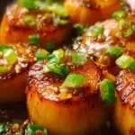 Honey Garlic Butter Scallops served on a plate with garnishes