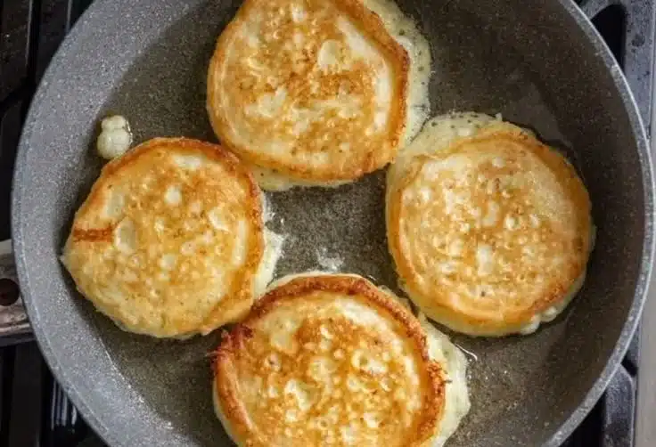 Delicious cottage cheese pancakes served with fresh fruit and syrup