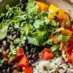 Delicious and colorful black bean rice bowl topped with fresh ingredients