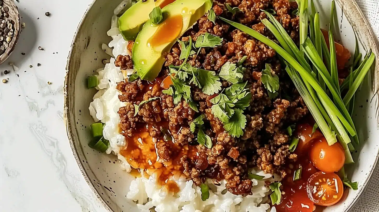 Hot Honey Glazed Ground Beef Bowl served with fresh vegetables and rice