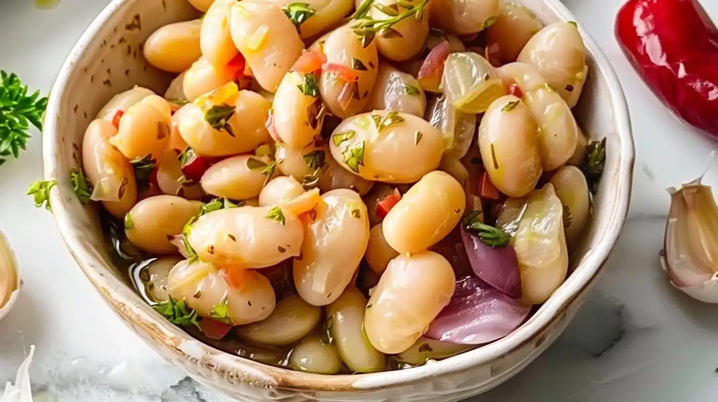 Delicious marinated butter beans in a bowl with herbs and spices